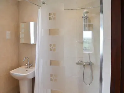 a bathroom with a shower and a sink at The Yellow House in Padstow