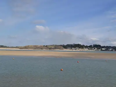 a body of water with a beach in the background at The Yellow House in Padstow