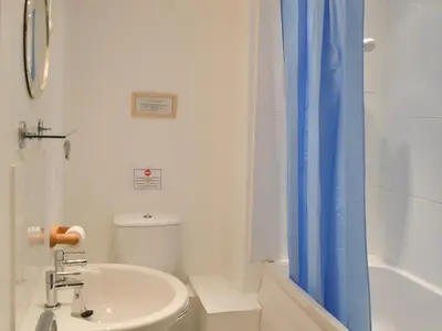 a bathroom with a sink and a toilet and a shower at 7 Quarrymans Cottage in Wadebridge