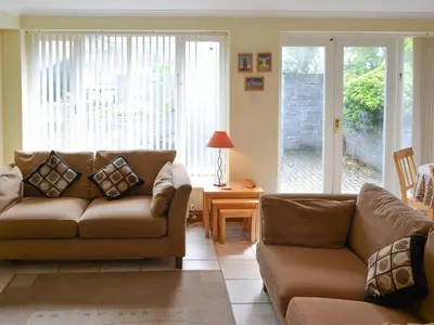 a living room with a couch and a table at Sea Shells in Padstow
