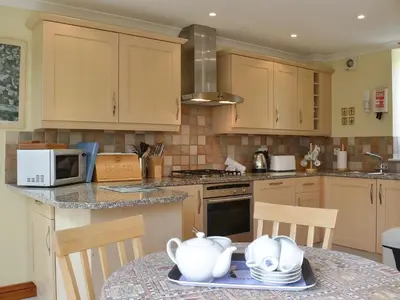 a kitchen with a table with a tea set on it at Sea Shells in Padstow