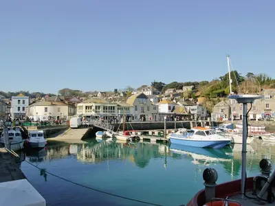 a group of boats are docked in a harbor at Sea Shells in Padstow