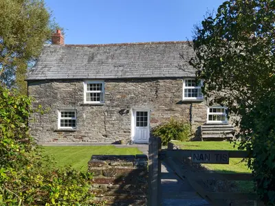 a stone house with a sign in front of it at Nan-Tis in St. Issey