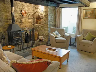 a living room with couches and a fireplace at Nan-Tis in St. Issey