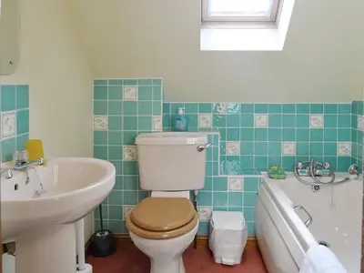 a bathroom with a toilet and a sink and a tub at Spring Tides in Padstow
