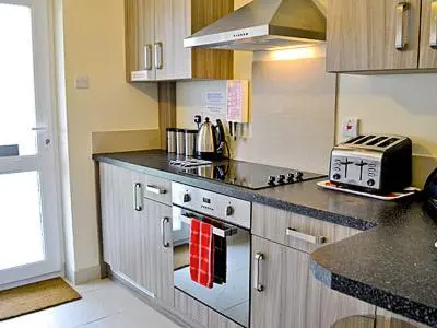 a kitchen with a stove and a counter top at Blue Waves in Perranporth