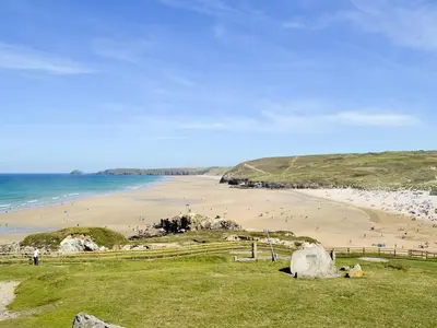 a beach with a bunch of people on the sand at Blue Waves in Perranporth