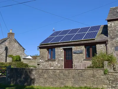 a house with solar panels on the roof at Roosters Perch in Saint Kew