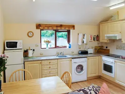 a kitchen with a sink and a dishwasher at Roosters Perch in Saint Kew