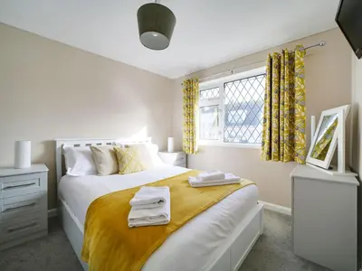 a bedroom with a bed with towels on it at Sea Thrift in Port Isaac