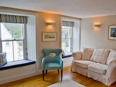 a living room with a couch and a chair at Mainbrace in Port Isaac