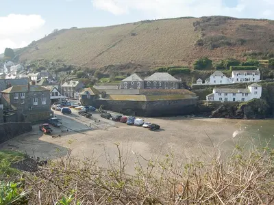 a small town with houses and a mountain at Mainbrace in Port Isaac