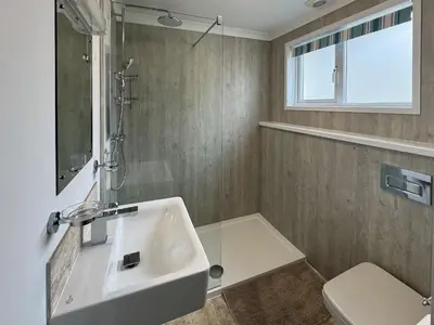a bathroom with a sink and a shower and a toilet at Lower Moon in Port Isaac