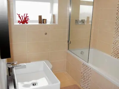 a bathroom with a toilet and a sink and a shower at The Lookout in Port Isaac