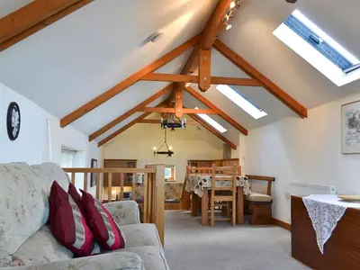 a living room with a couch and a table at Saundry's Barn in Port Isaac