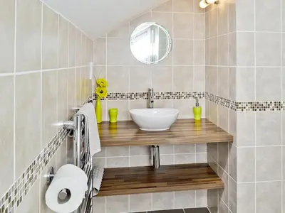 a bathroom with a sink and a mirror at Owls Park in Saint Endellion
