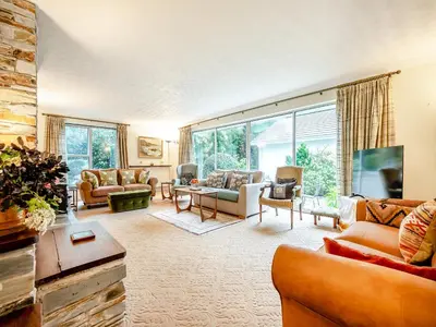 a living room with furniture and a large window at Pennard in Tuckingmill