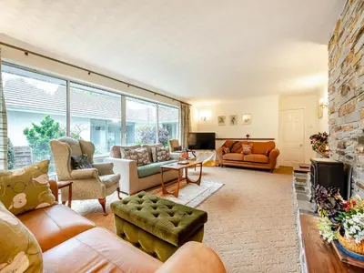 a living room filled with furniture and a large window at Pennard in Tuckingmill