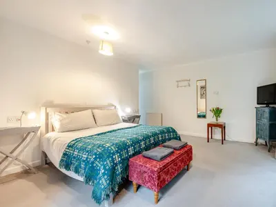 a bedroom with a bed and a table and a tv at Pennard in Tuckingmill