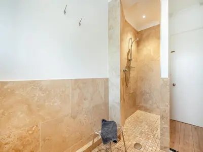 a bathroom with a shower with a glass door at Pennard in Tuckingmill