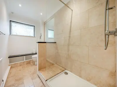 a bathroom with a shower and a toilet at Pennard in Tuckingmill