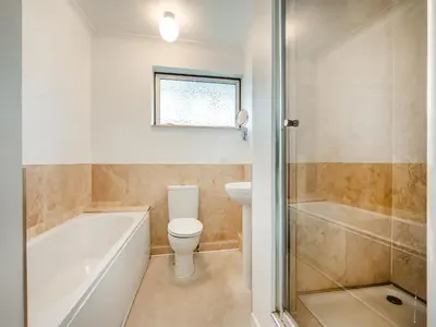 a bathroom with a tub and a toilet and a sink at Pennard in Tuckingmill