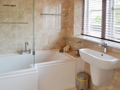 a bathroom with a sink and a bath tub and a sink at 2 The Courtyard in Portreath
