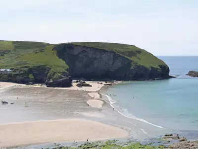 a group of people on a beach near the ocean at 2 The Courtyard in Portreath