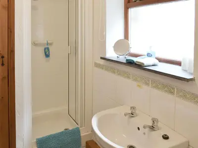 a bathroom with a sink and a shower at Ash Tree Cottage in Carnbrea