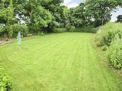 a green field with a sign in the middle of it at The Old Dairy in Mount Hawke