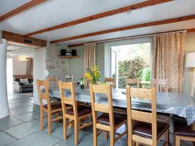 a dining room with a table and chairs at The Farm House in Porkellis
