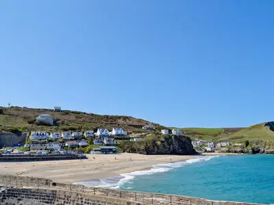 a view of a beach with houses and the ocean at Maple Barn in Porthtowan