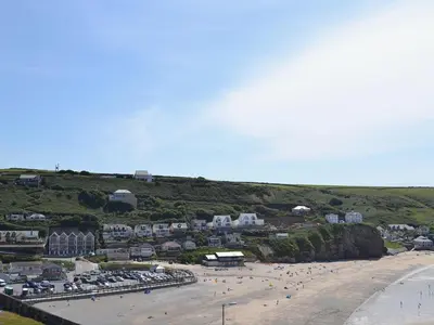 a beach with a bunch of people on the sand at Oak Barn in Porthtowan