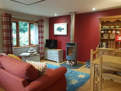 a living room with a couch and a television at Penty-Lowarth in Saint Columb Major