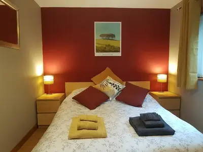 a bedroom with a bed with two pillows on it at Penty-Lowarth in Saint Columb Major