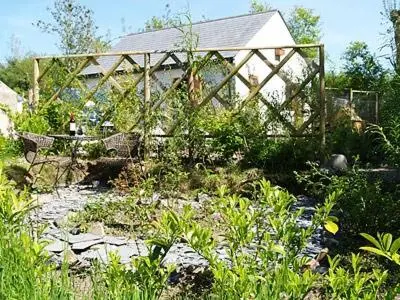 a garden with a wooden structure in the background at Penty-Lowarth in Saint Columb Major