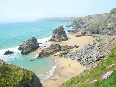 a view of a beach with rocks and the ocean at Penty-Lowarth in Saint Columb Major