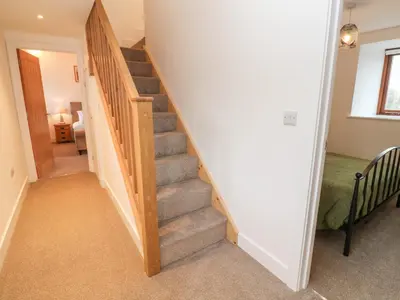 a stairway in a home with a stair case at Pol View in Helston