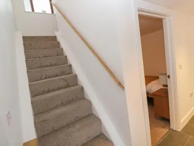 a staircase leading up to a bedroom in a house at Pol View in Helston