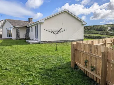 a house with a net on the side of it at Trewethett Farm in Forrabury