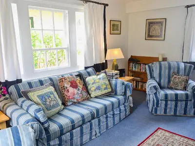 a living room with a couch and two chairs at Keeper's Cottage in Helford Passage