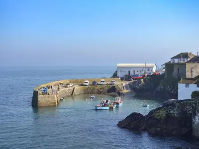 a group of people on a boat in the water at Ponsgwedhen in Coverack