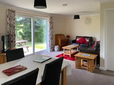 a living room with a table and a couch at Tresco - B6520 in Saint Cleer