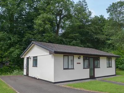 a small white building with a black roof at Heligan - B6522 in Saint Cleer