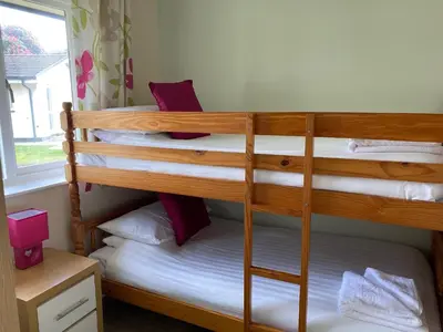 two bunk beds in a room with a window at Heligan - B6522 in Saint Cleer