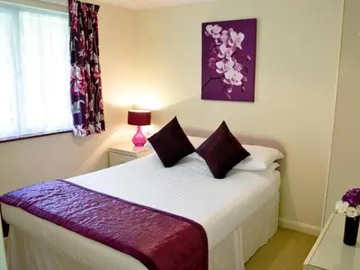 a bedroom with a bed with purple and white sheets at Trevarno - B6527 in Saint Cleer