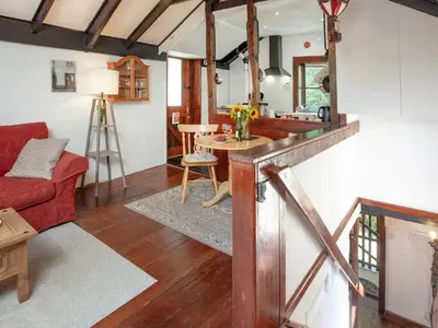 a living room with a red couch and a table at Alyshan in Merrymeet
