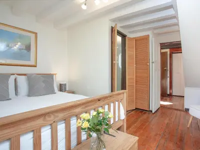 a bedroom with a bed with a vase of flowers at Alyshan in Merrymeet