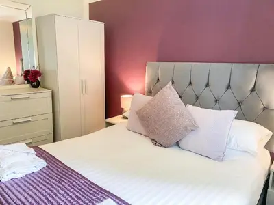 a bedroom with a bed with two pillows on it at Talland Bay in Saint Cleer