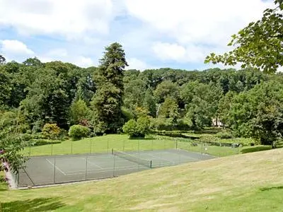 a tennis court in the middle of a field at Seaton in Saint Cleer